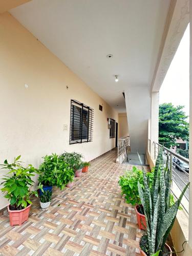 a balcony with potted plants in a building at Shreya's Homestay, Your Sacred Nest in Ujjain