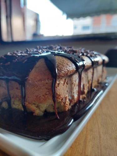 a chocolate cake on a plate on a table at Encantos do mar in Arraial do Cabo
