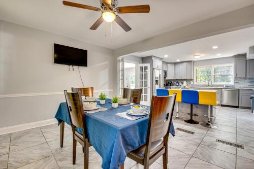 a dining room and kitchen with a blue table and chairs at Spacious Home with Hot Tub, 14 Mi to Downtown ATL! in Union City