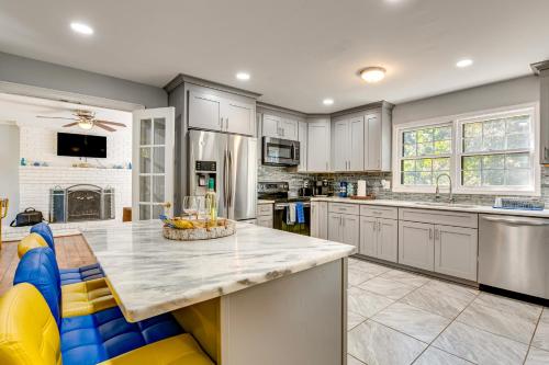 a kitchen with white cabinets and a large island at Spacious Home with Hot Tub, 14 Mi to Downtown ATL! in Union City
