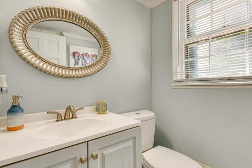 a bathroom with a sink and a mirror at Spacious Home with Hot Tub, 14 Mi to Downtown ATL! in Union City