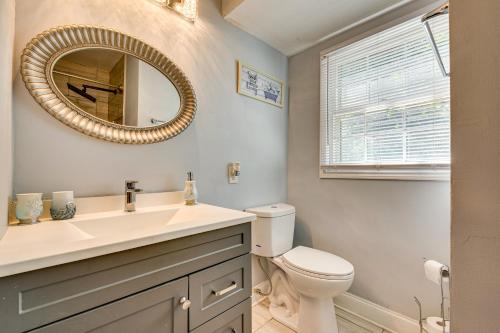 a bathroom with a sink and a toilet and a mirror at Spacious Home with Hot Tub, 14 Mi to Downtown ATL! in Union City