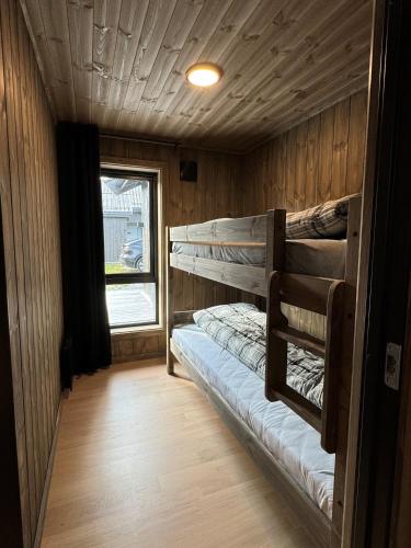 a room with two bunk beds in a cabin at Roaldsida Retreat in Stranda