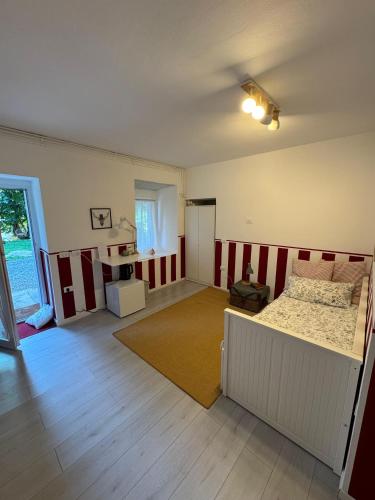 an empty room with a bed and a window at La Cascina di Bea in Torre Boldone