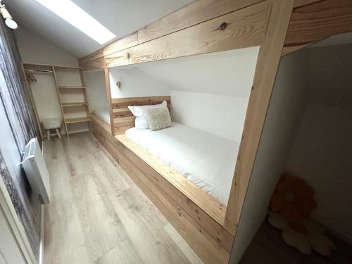 a small room with a white bed in it at Gîte des 4 saisons in Rupt-sur-Moselle