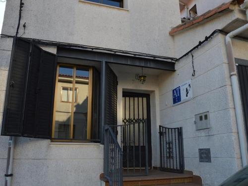 a building with black doors and a balcony at Manomar II, tu refugio en Gata in Gata