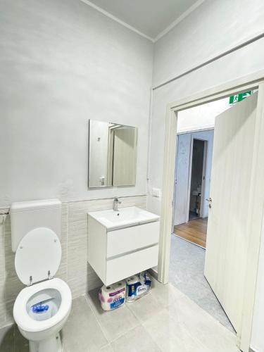 a bathroom with a toilet and a sink and a mirror at Guest House Romoli in Rome