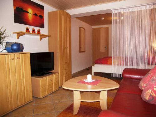 a living room with a couch and a table with a candle at Ferienwohnung Krentz in Neu Sallenthin