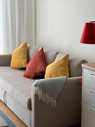 a couch with pillows on it in a living room at Haga Home in Tallinn