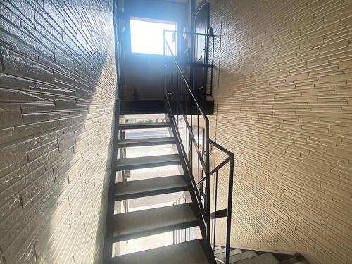 a spiral staircase in a building with a window at Tasogare Apartment 201 in Hakodate
