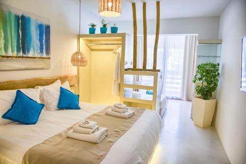 a bedroom with a large bed with towels on it at Alia Suites and Spa in Haraki