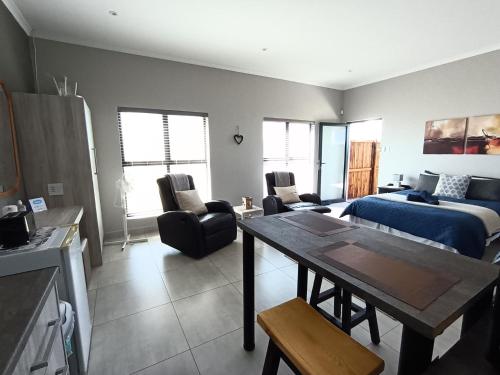 a living room with a couch and a table in it at Silver Oaks Airbnb in Langebaan
