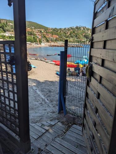 - une vue sur la plage depuis une clôture en bois dans l'établissement Magnifique loft sur la plage Life is a Beach GuestHouse, à Théoule-sur-Mer