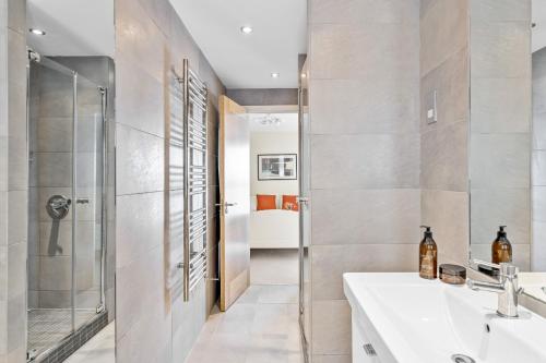 a bathroom with a sink and a shower at B6 Masts - With sea views, parking and terrace in Torquay