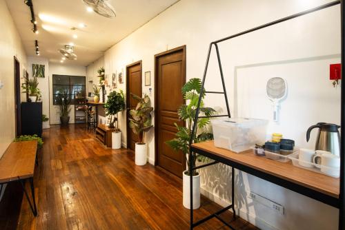 a hallway with potted plants in a room at Homey and Cozey Poblacion Makati S02 in Manila