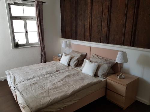 a bedroom with a large bed and a window at Lutherwohnung Schmalkalden in Schmalkalden