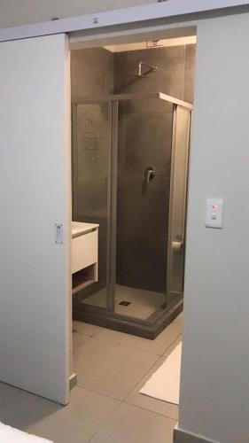 a bathroom with a shower with a glass door at Mya Villa 2 in Fourways