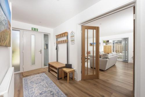 a living room with a door open to a living room at Tre Lowen, Goonhavern, Perranporth - Free Parking - Free Wifi - Games Room in Perranporth