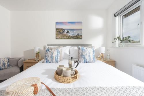 a bedroom with a bed with a basket on it at Tre Lowen, Goonhavern, Perranporth - Free Parking - Free Wifi - Games Room in Perranporth