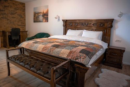 a bedroom with a bed with a quilt on it at Boutique Marlen in Ghimbav