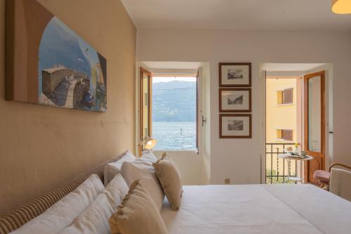 a bedroom with a bed with a view of the ocean at Il Porticciolo by Rent All Como in Carate Urio