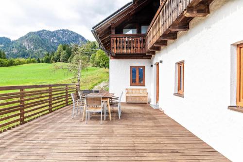 a wooden deck with a table and chairs on a house at Kärntner Bauernhaus in Panoramalage in Laas