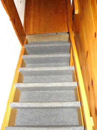 a set of stairs in a room with wooden floors at Chesa Panorama in Celerina