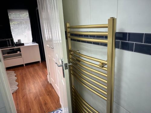 a room with a door with blue tiles on the wall at Double Bedroom inside Family Home in Nottingham