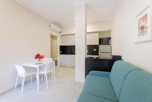 a living room with a blue couch and a table at Camping Bungalow Lido in Capoliveri