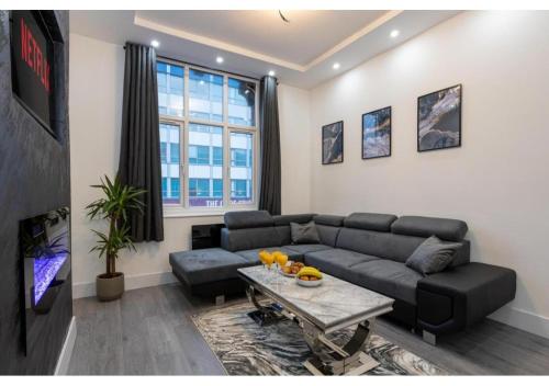 a living room with a couch and a table at Spacious Manchester Duplex 2BR Parking Sleeps 6 in Bolton