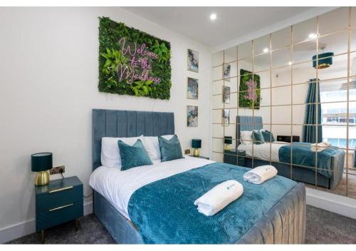a bedroom with a large bed with a blue blanket at Spacious Manchester Duplex 2BR Parking Sleeps 6 in Bolton