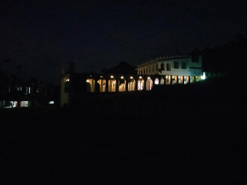 a building lit up at night with lights at JK Home stay in Sultan Bathery