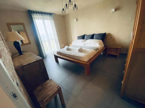 a bedroom with a bed and a table with a lamp at Cascina Bricco San Pietro Bed & Wine in Monforte dʼAlba