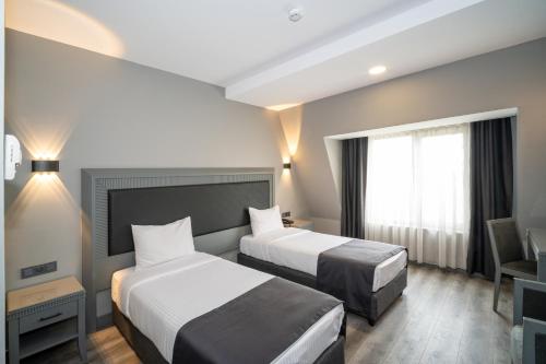Postel nebo postele na pokoji v ubytování Grand S Hotel