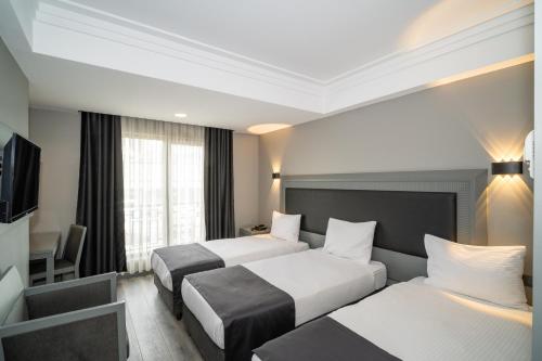 Postel nebo postele na pokoji v ubytování Grand S Hotel