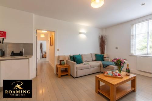 a living room with a couch and a table at Extended Stay Accommodation for Professionals & Families in Reading