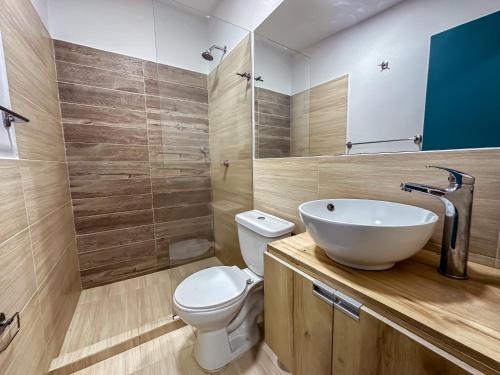 a bathroom with a sink and a toilet at Hotel Casamart Rodadero in Santa Marta