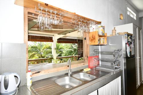 a kitchen with a sink and a window at Villa de la Vallée in Rodrigues Island