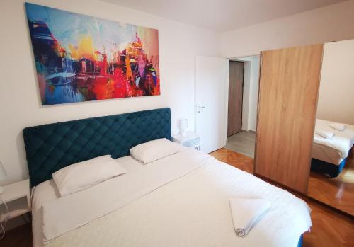 a bedroom with a bed and a painting on the wall at The Silken Symphony in Niš