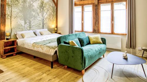 une chambre avec un lit, un canapé et une chaise dans l'établissement Le Loft Boucherat - Hypercentre - 2 pers, à Troyes