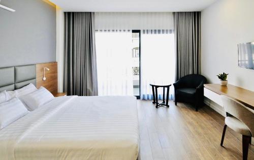 Postel nebo postele na pokoji v ubytování Royal Dragon Boutique Hotel