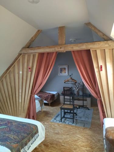 une chambre avec un lit et un bureau dans une pièce dans l'établissement Grand gîte sauna et bain bouillonnant 15 pers, à Cavron-Saint-Martin