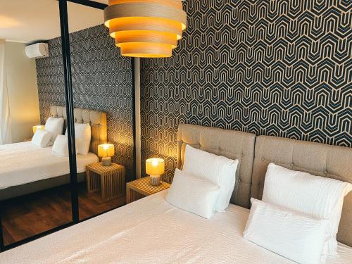 - une chambre avec un lit et deux lampes sur les tables dans l'établissement La Terrasse de l'Esterel, à Mandelieu-la-Napoule