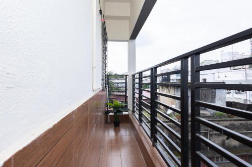 a balcony with a plant on the side of a building at Lakeside Suites in Kolkata
