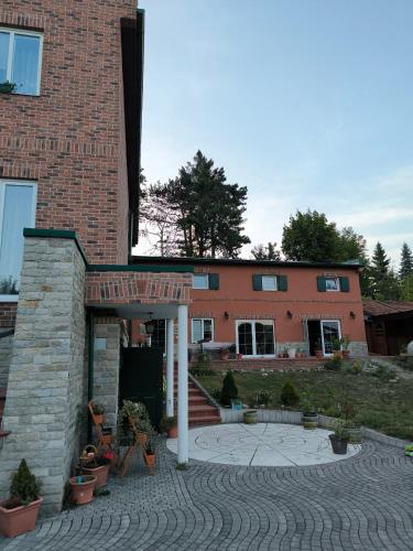 a brick building with a courtyard in front of it at Apartmán pri vinotéke in Kežmarok
