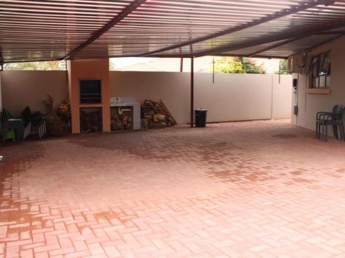a large room with a patio with a table and chairs at Connesione Mogwase in Mabele-a-podi