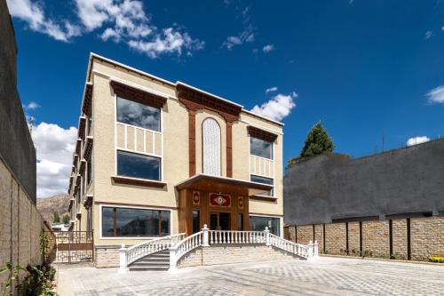 a building with a staircase in front of it at Charmwood Hotel in Leh