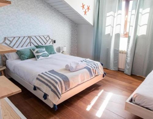 a bedroom with a large bed with white and blue pillows at Camino Blanco in Ibeas de Juarros