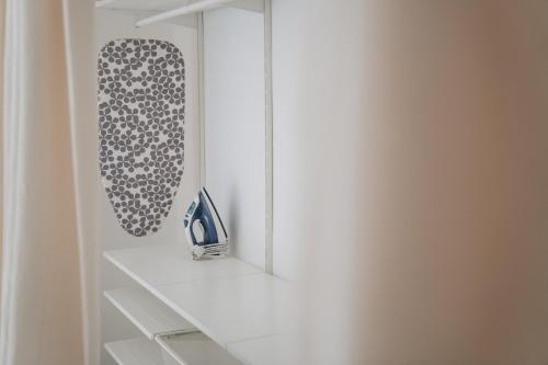 a white closet with a shelf and a mirror at Holiday House Aguacate 2 in San Sebastián de la Gomera
