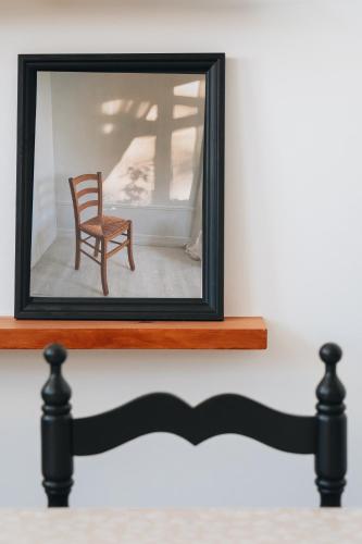 a mirror on a shelf with a chair in it at Holiday House Aguacate 2 in San Sebastián de la Gomera